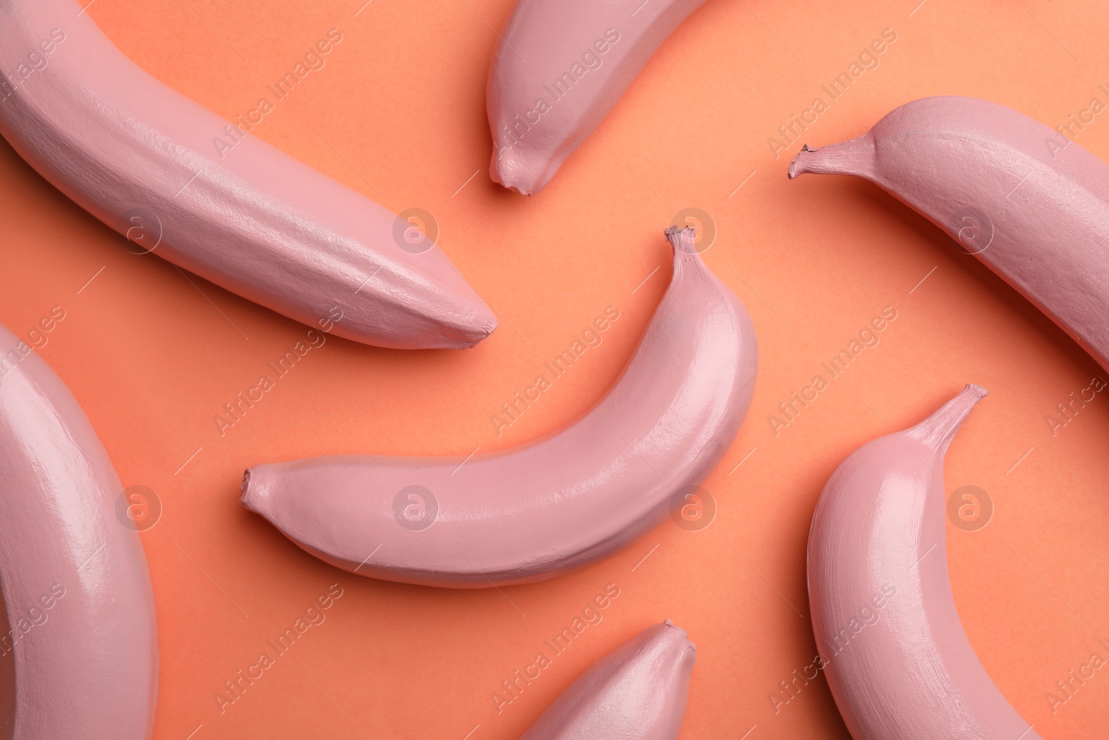 Photo of Flat lay composition with painted bananas on coral background