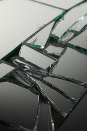 Photo of Shards of broken mirror on backing board, closeup