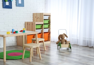 Photo of Modern child room interior with table and stools