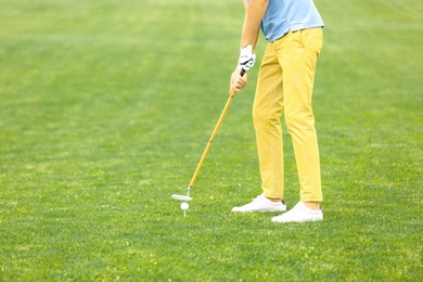 Man playing golf on green course. Sport and leisure
