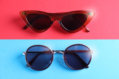 Photo of Stylish sunglasses on color background, flat lay
