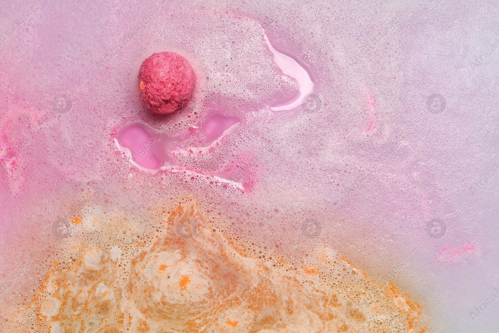 Photo of Beautiful pink bath bomb dissolving in water