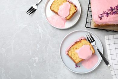 Photo of Delicious cake with pink glaze served on light marble table, flat lay. Space for text