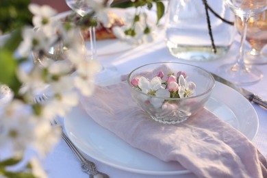 Photo of Stylish table setting with beautiful spring flowers in garden