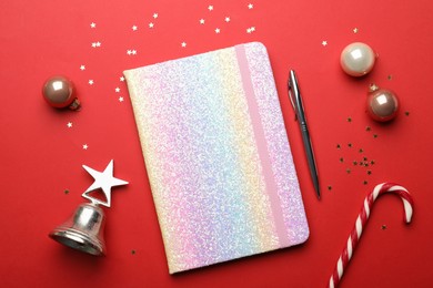bright planner and Christmas decor on red background, flat lay