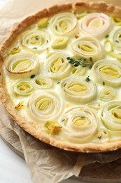 Tasty leek pie with thyme on white table, closeup