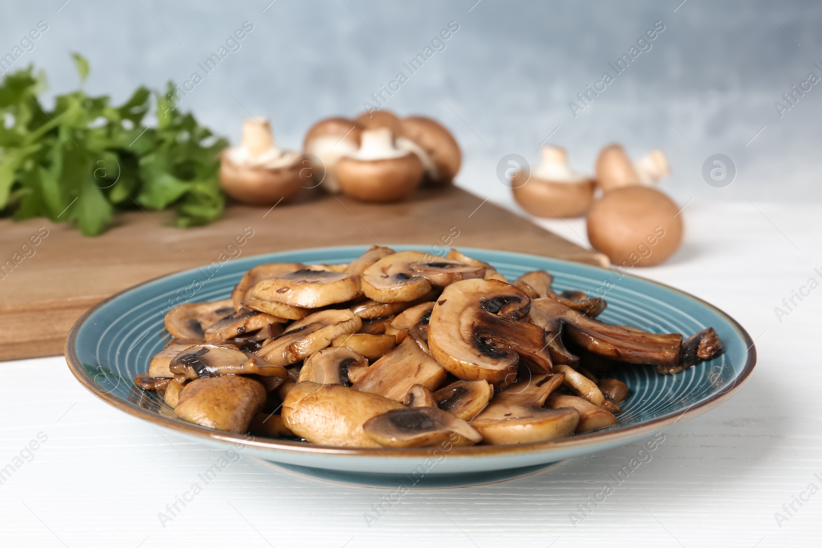 Photo of Plate of fried mushrooms on table, closeup