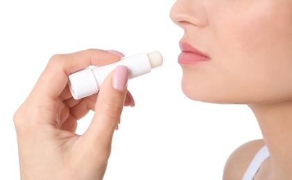 Woman applying hygienic lip balm, on white background