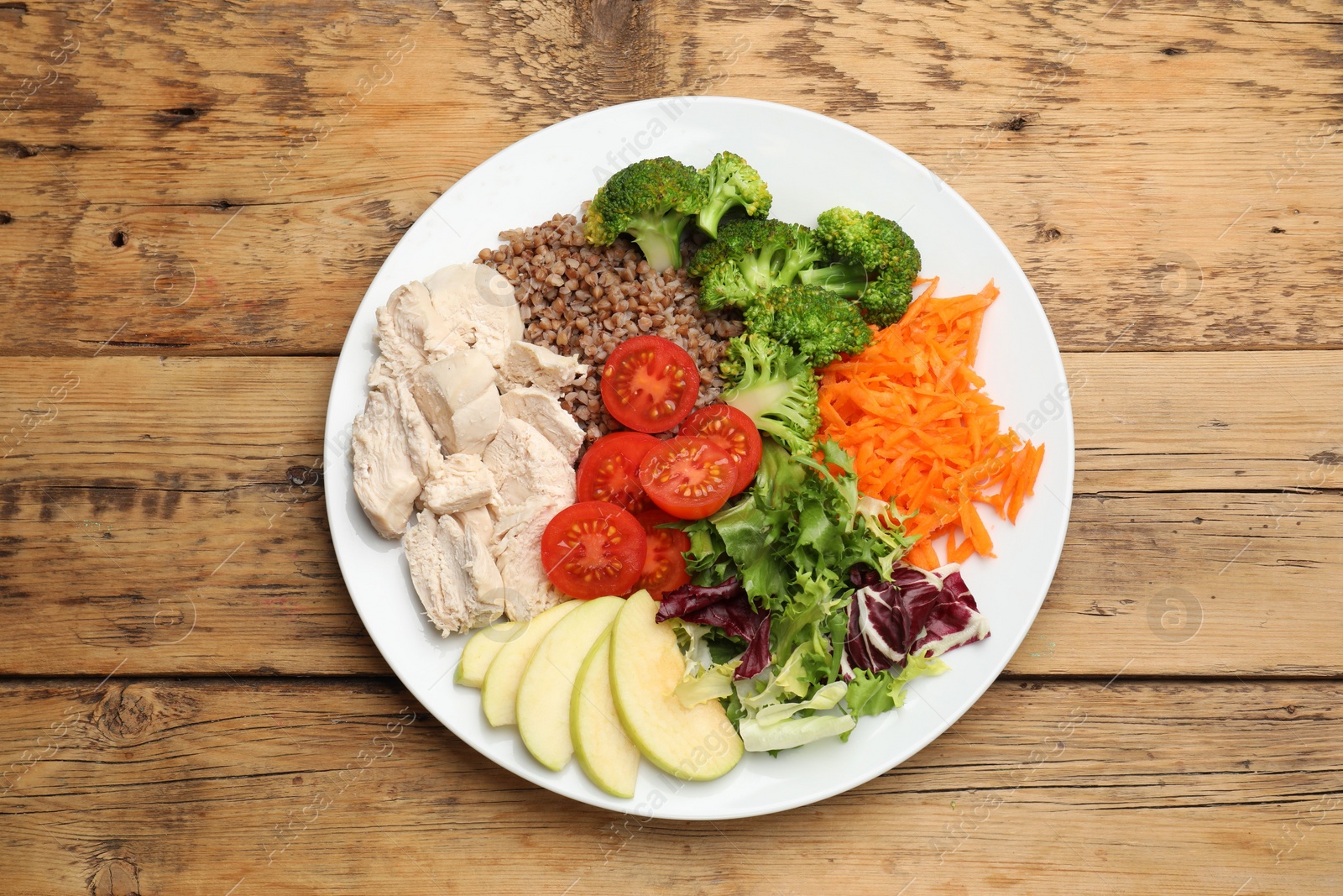 Photo of Balanced diet and healthy foods. Plate with different delicious products on wooden table, top view