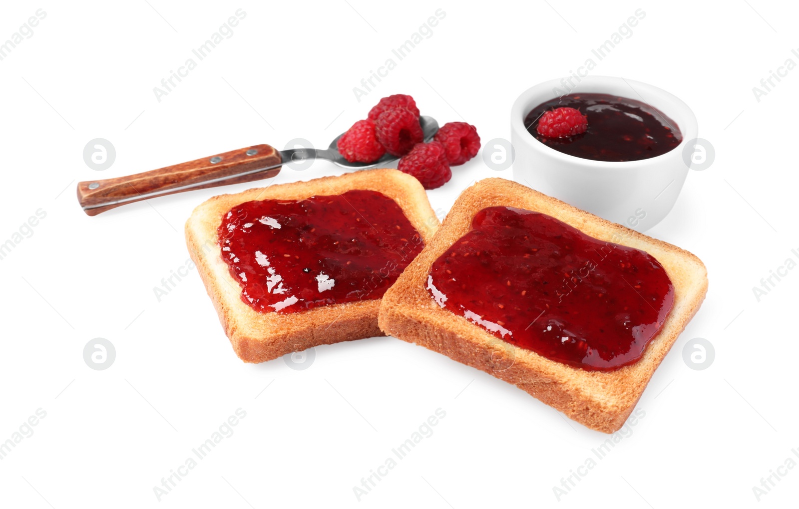 Photo of Crispy toasts with jam, spoon and raspberries on white background