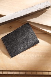 One coarse sandpaper on wooden planks, top view