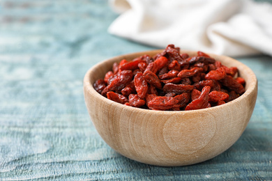 Photo of Dried goji berries on blue wooden table