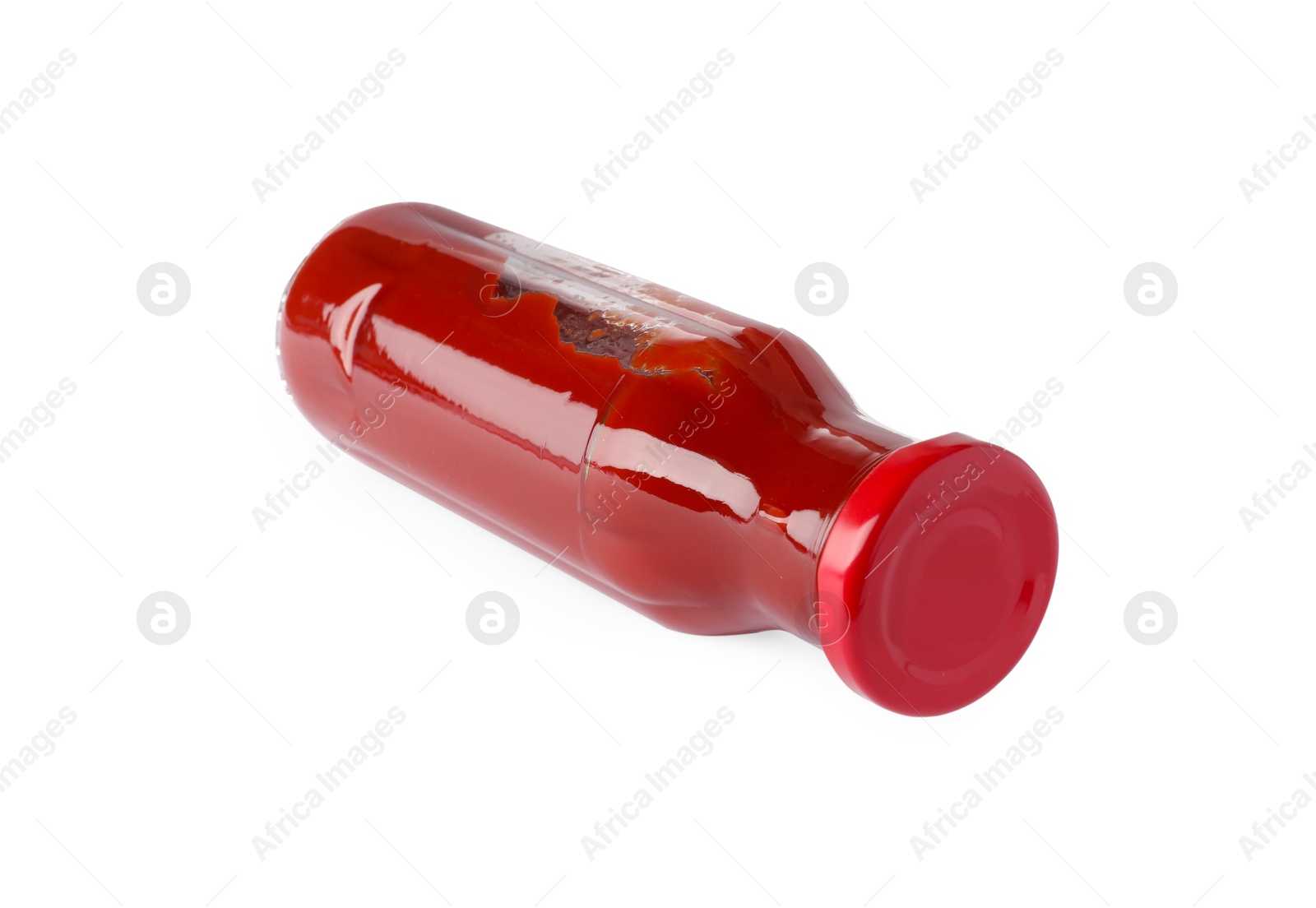 Photo of Glass bottle of tasty ketchup isolated on white