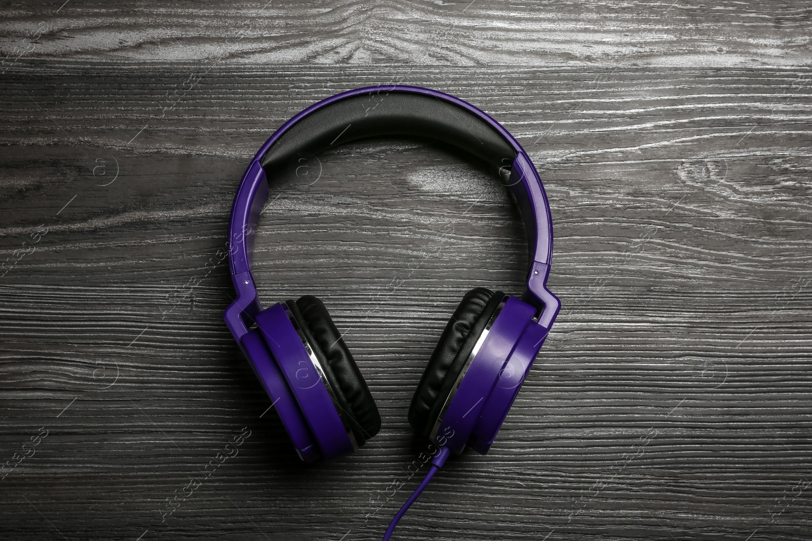 Photo of Stylish headphones on wooden background, top view