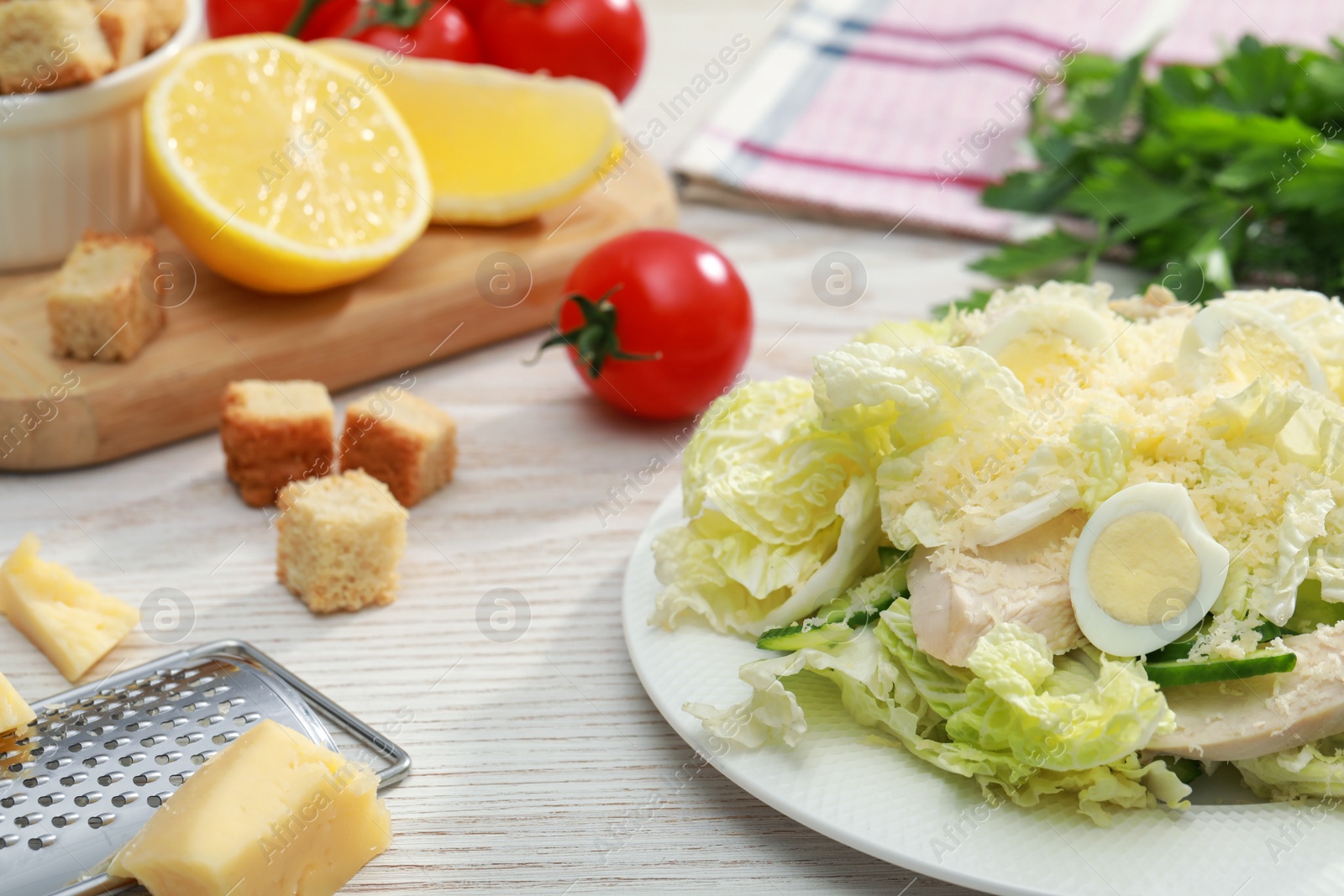 Photo of Delicious salad with Chinese cabbage, eggs and meat served on wooden table, space for text