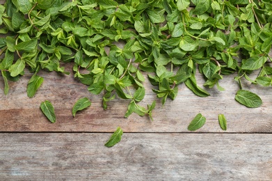 Photo of Fresh aromatic mint on wooden background, top view