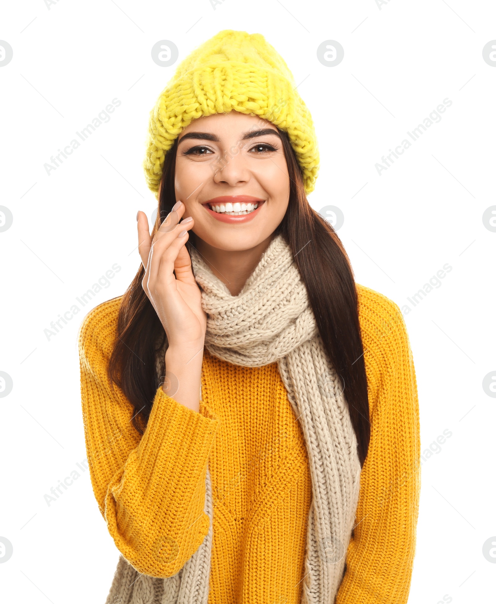 Photo of Happy young woman in warm clothes on white background. Winter vacation