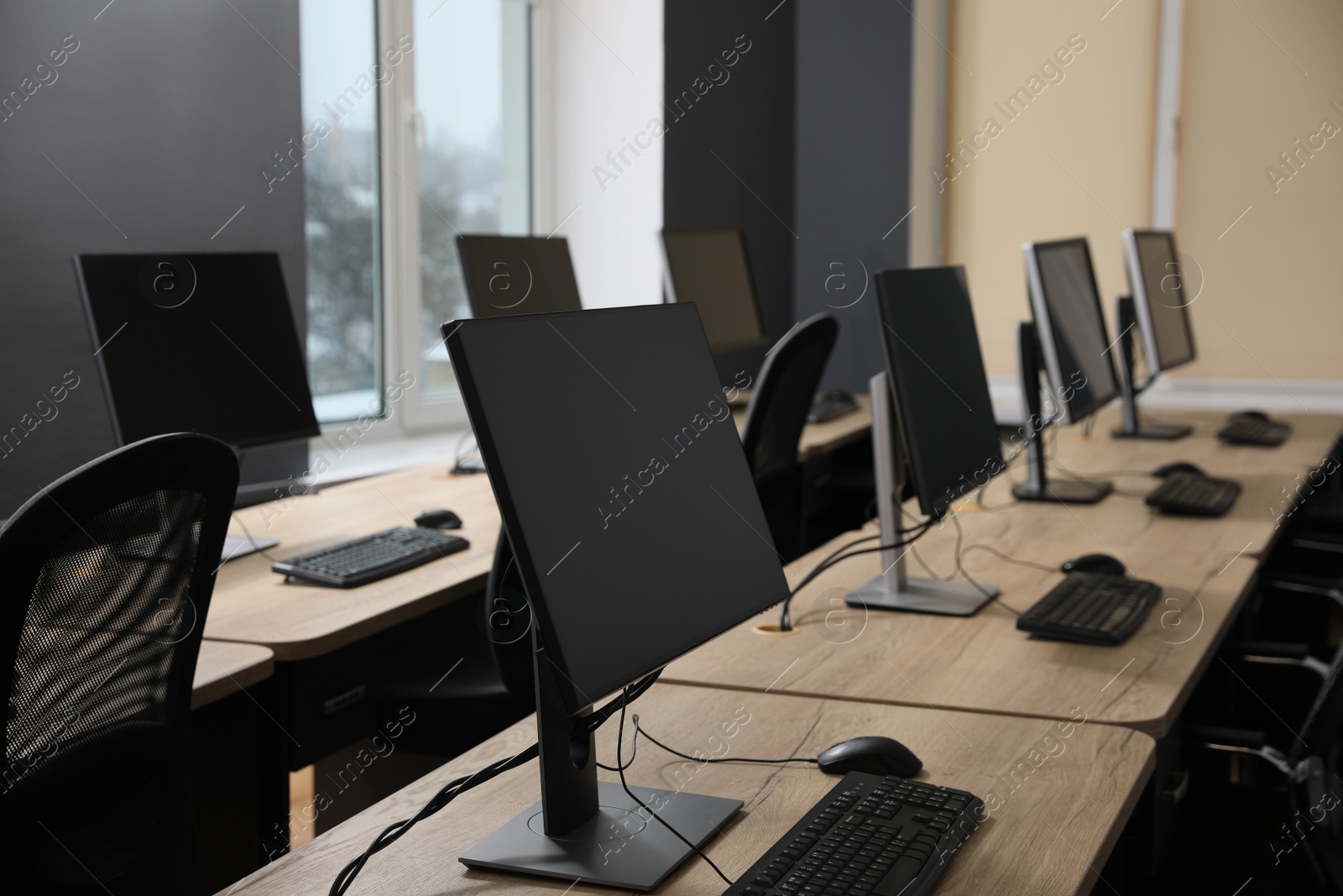 Photo of Many modern computers in open space office