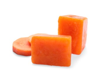 Photo of Frozen carrot puree cubes and fresh carrot isolated on white
