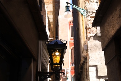 Beautiful antique lamp hanging on city street