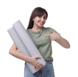 Photo of Beautiful woman pointing at wallpaper rolls on white background
