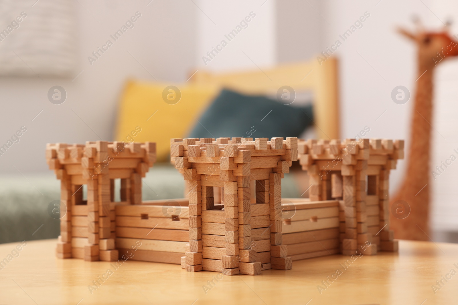 Photo of Wooden fortress on table indoors. Children's toy