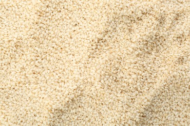 Photo of Pile of white sesame seeds as background, top view