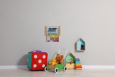 Beautiful children's room with grey wall and toys. Interior design