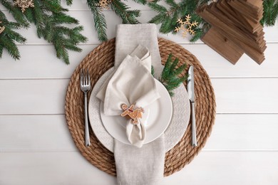 Beautiful festive place setting with stylish decor for Christmas dinner on white wooden table, flat lay