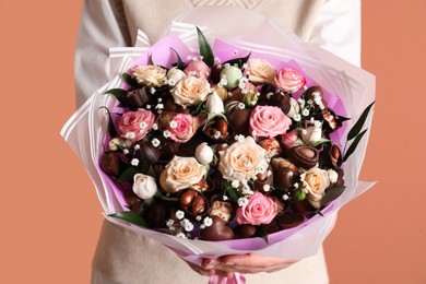 Photo of Woman with beautiful food bouquet on brown background, closeup