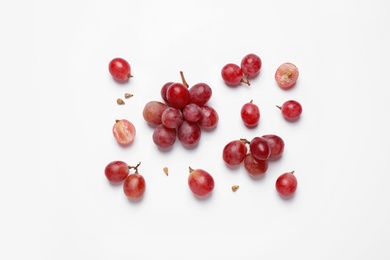 Composition with fresh ripe grapes and seeds on white background, top view