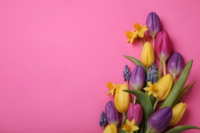 Beautiful different flowers on pink background, flat lay. Space for text