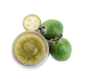 Feijoa jam in glass jar and fruits on white background, top view