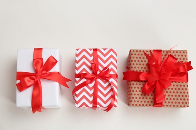 Beautifully decorated gift boxes on white background, top view