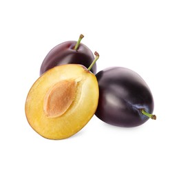 Whole and cut ripe plums on white background