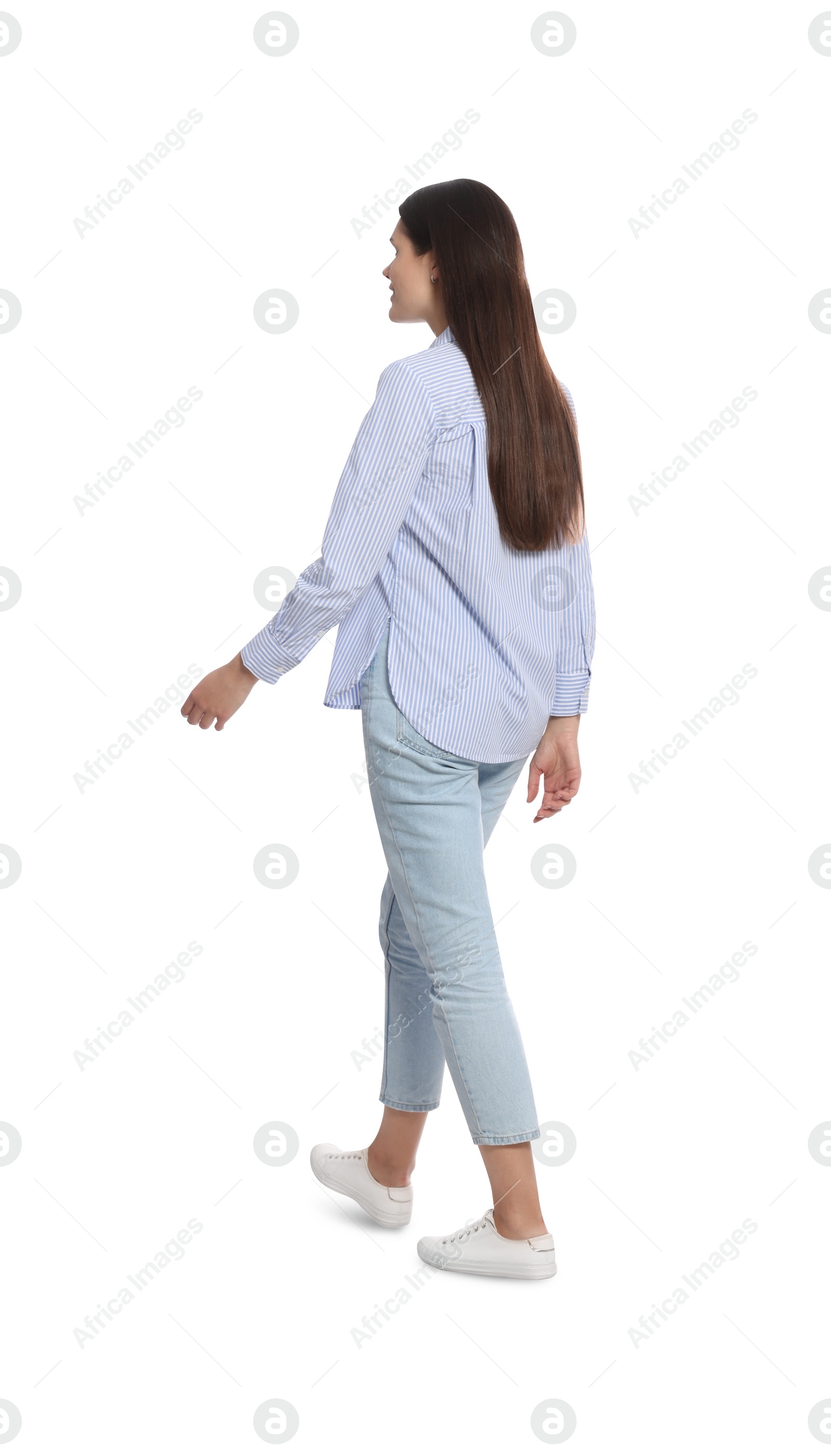 Photo of Young woman in stylish outfit walking on white background