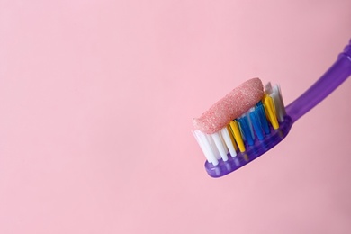 Toothbrush with paste on color background, closeup