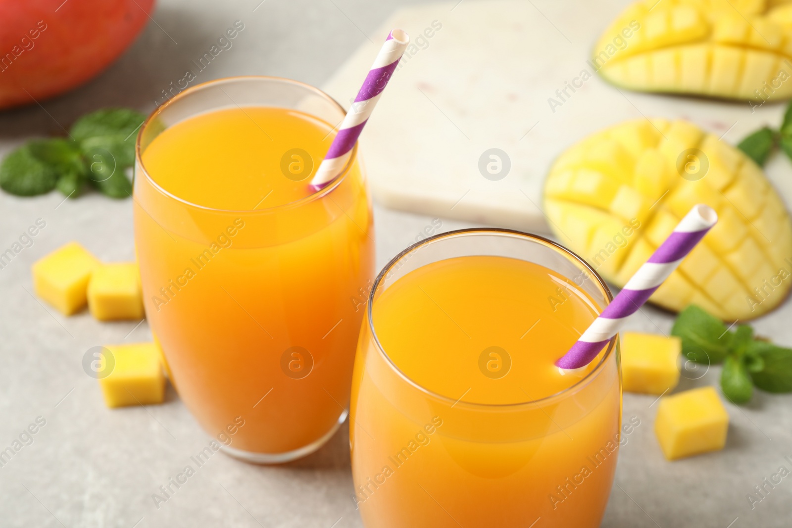 Photo of Fresh delicious mango drink on light table