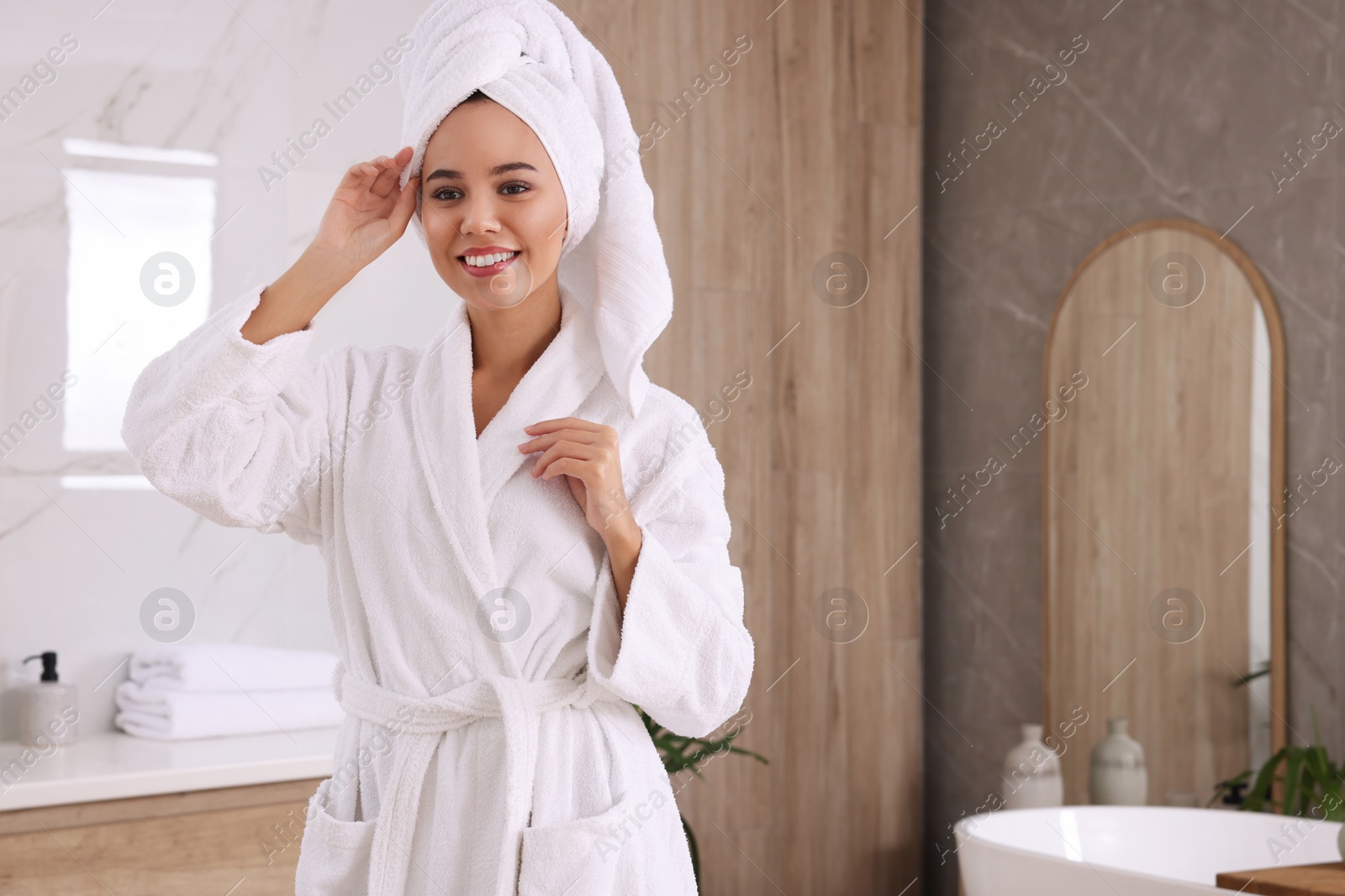 Photo of Beautiful African American woman in bathroom, space for text