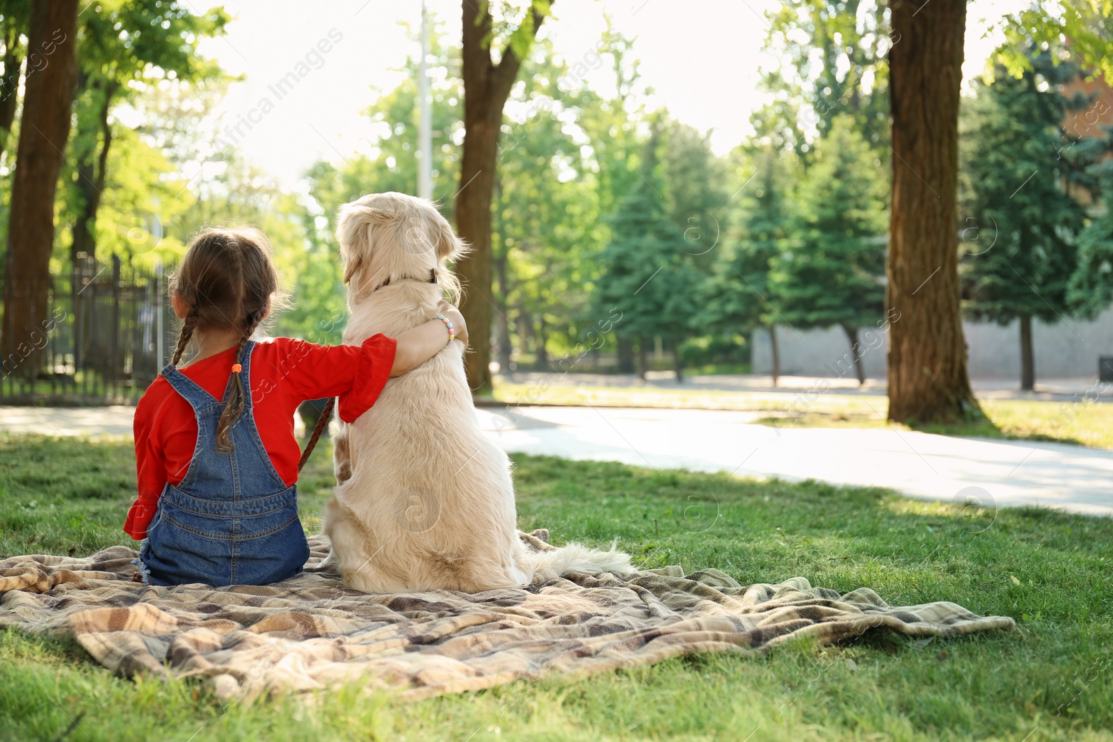 Photo of Cute little child with his pet in green park