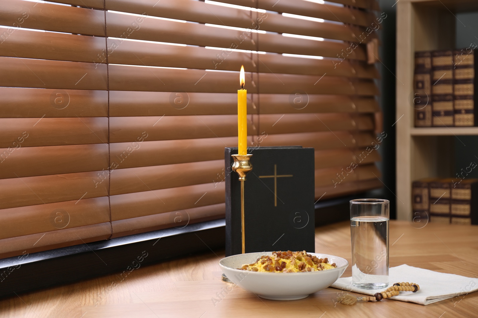 Photo of Great Lent dinner, Bible and candle near window indoors. Space for text