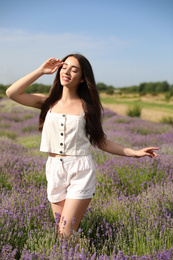 Young woman in lavender field on summer day