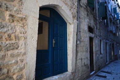 Old residential building with blue wooden door