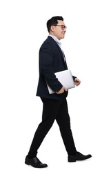 Photo of Businessman in suit with laptop walking on white background