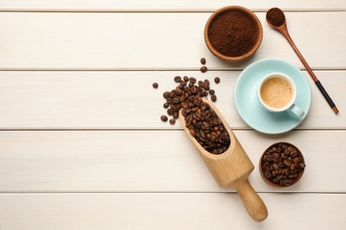 Coffee beans, powder and cup of drink on white wooden table, flat lay. Space for text