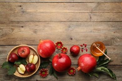 Photo of Flat lay composition with Rosh Hashanah holiday attributes on wooden table. Space for text