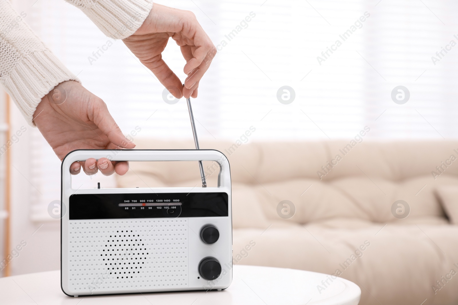 Photo of Woman adjusting radio antenna at home, closeup. Space for text