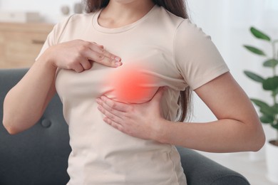 Image of Woman doing breast self-examination at home, closeup