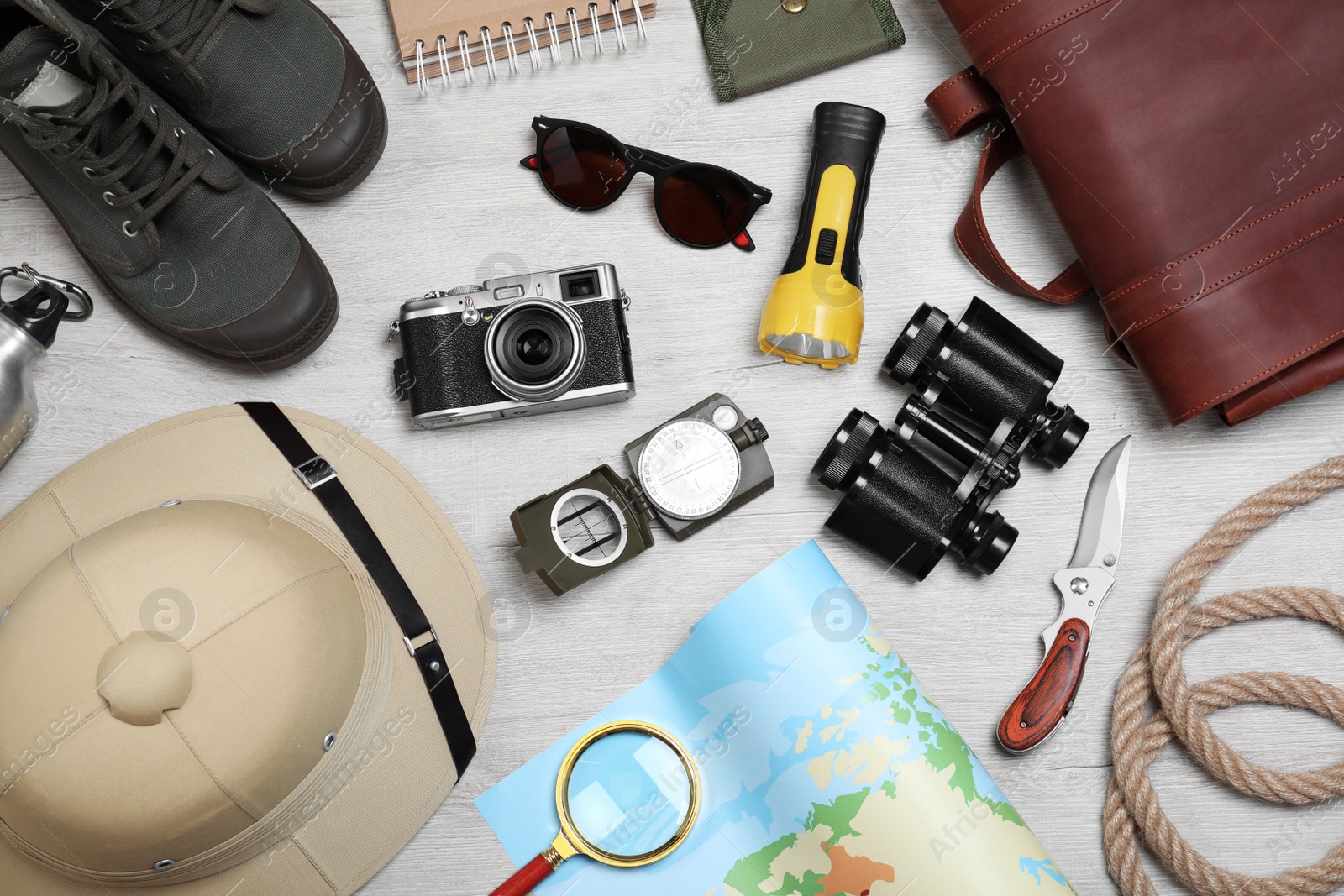 Photo of Flat lay composition with safari accessories on white wooden background