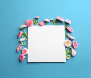 Photo of Flat lay composition with spring daisy flowers and card on color background. Space for text